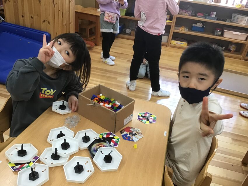 保育園には木のコマだけではなく、自分たちで組み合わせて色を作れるコマや、指で回せる物もあります。
コマを回す経験から指の力加減や手の力の加減も身に付いていきます。