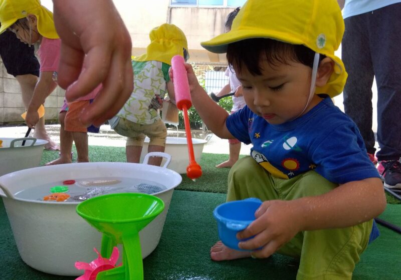 くるくる回る水車のおもちゃがお気に入り。何度も水を入れてみています！